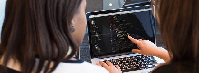 Developers pair-programming on a laptop